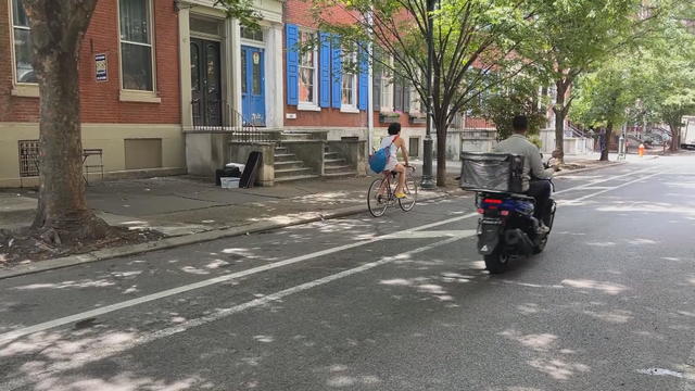 A bicyclist rides in the bike lane in Center City, Philadelphia 