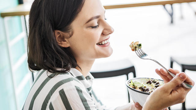 Young woman enjoying salad 