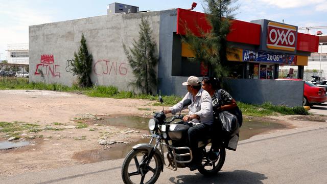 A bullet-riddled wall bearing the initials of the criminal group Cartel Jalisco Nueva Generacion (CJNG) is seen at the entrance of the community of Aguililla in the state of Michoacan, Mexico, on April 23, 2021. 